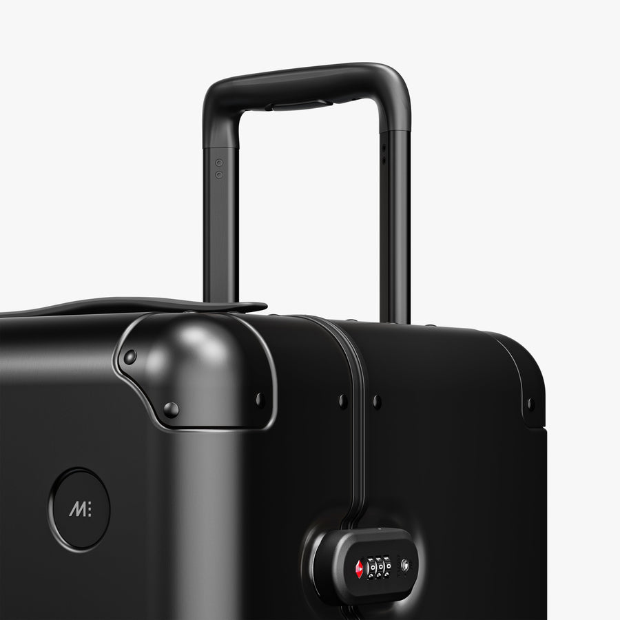 Caviar Black | Luggage handle view of Aluminum Trunk in Caviar Black