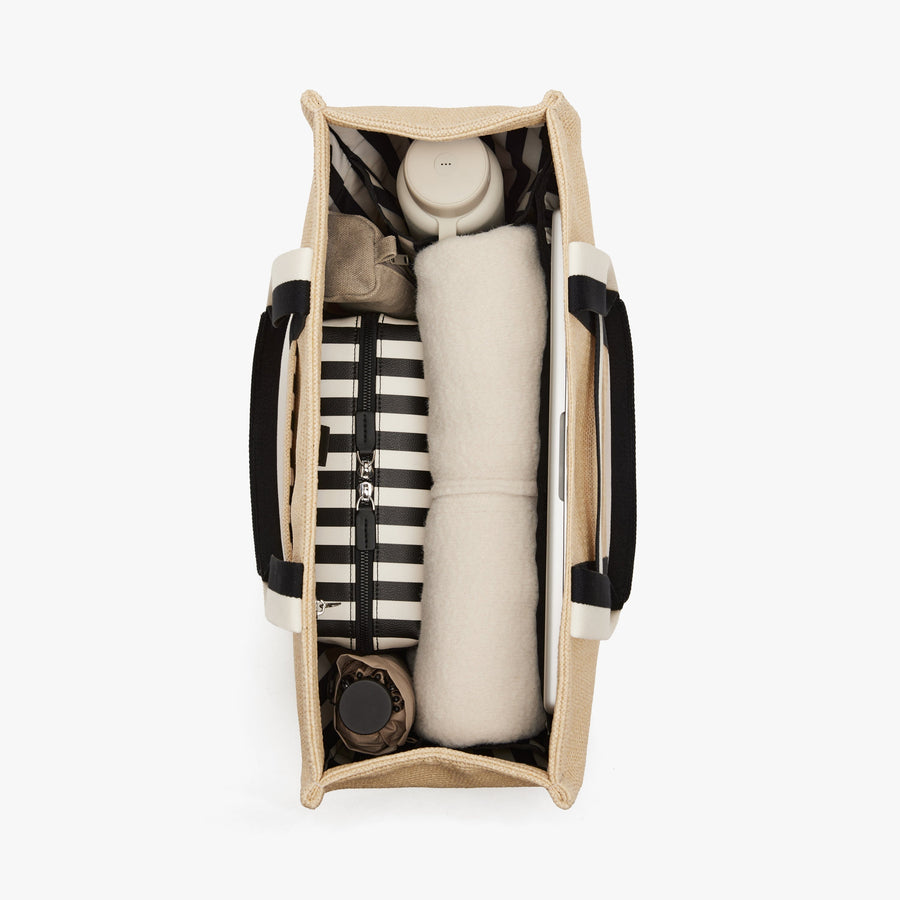 Natural | Interior view of Canopy Tote in Natural with travel essentials inside