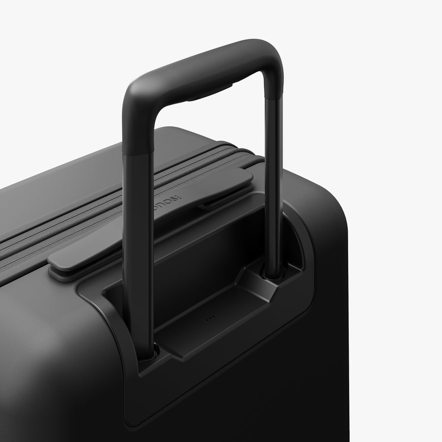 Midnight Black | Extended luggage handle view of Expandable Carry-On in Midnight Black