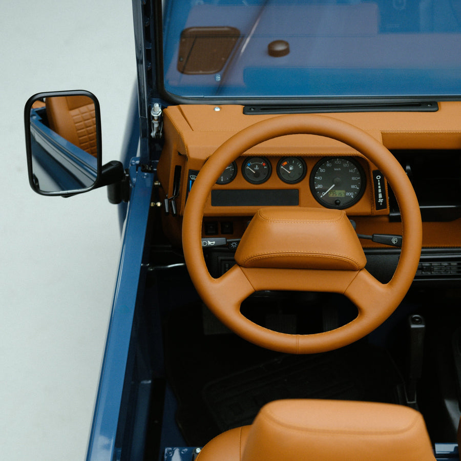 Arles Blue | Dashboard and steering wheel wrapped in saddle tan leather