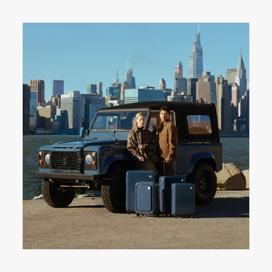 Set of Six / Arles Blue | Couple with Arles Blue suitcases by a car in New York City