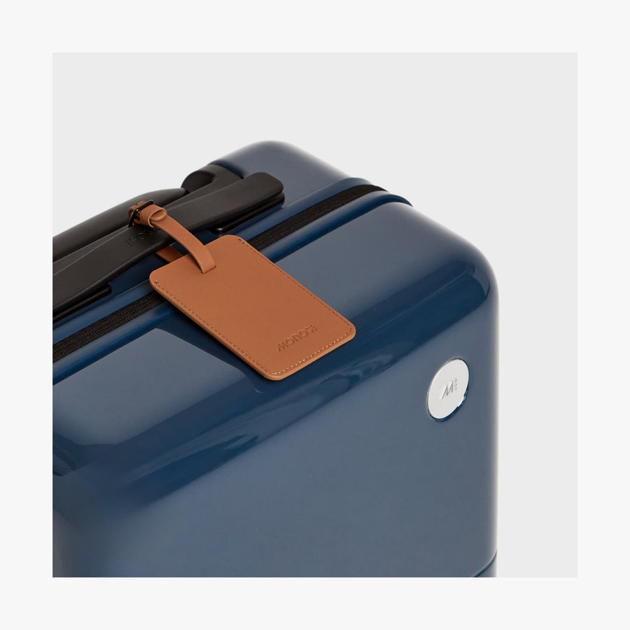 Arles Blue (Glossy) | Top view of suitcase in Arles Blue with a Luggage Tag