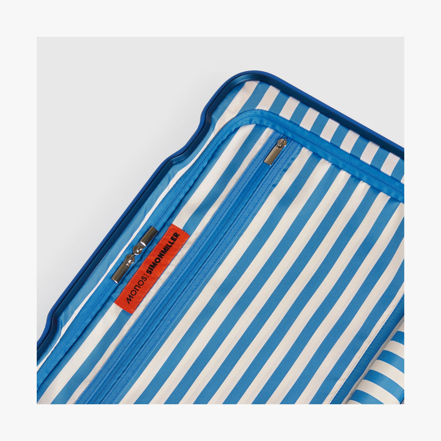Coastal Blue | Close-up view of the Hybrid suitcase interior in Coastal Blue, featuring the Poplin Stripe Coastal Blue zipped compartment