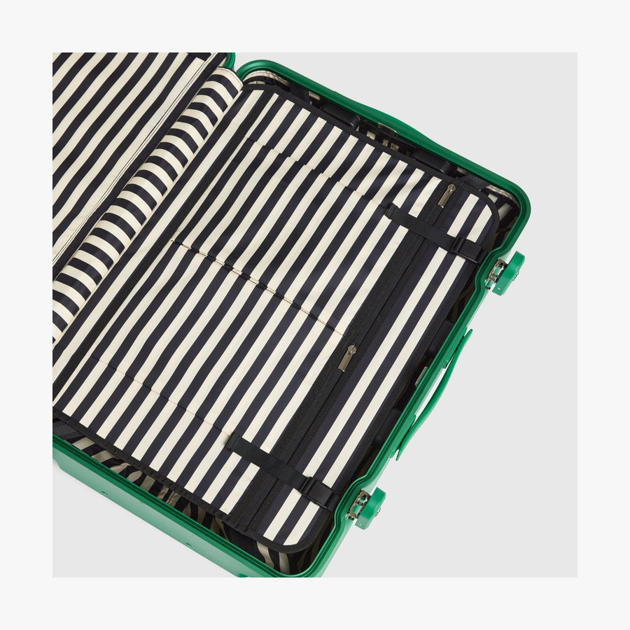 Jungle Green | Interior view of a Hybrid suitcase in Jungle Green featuring the Poplin Stripe Jungle Green compression pad with adjustable straps
