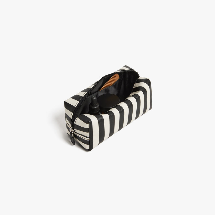 Small / Poplin Stripe Black | Back angled view of the opened small Metro Toiletry Case in Poplin Stripe Black, showing travel essentials stored inside