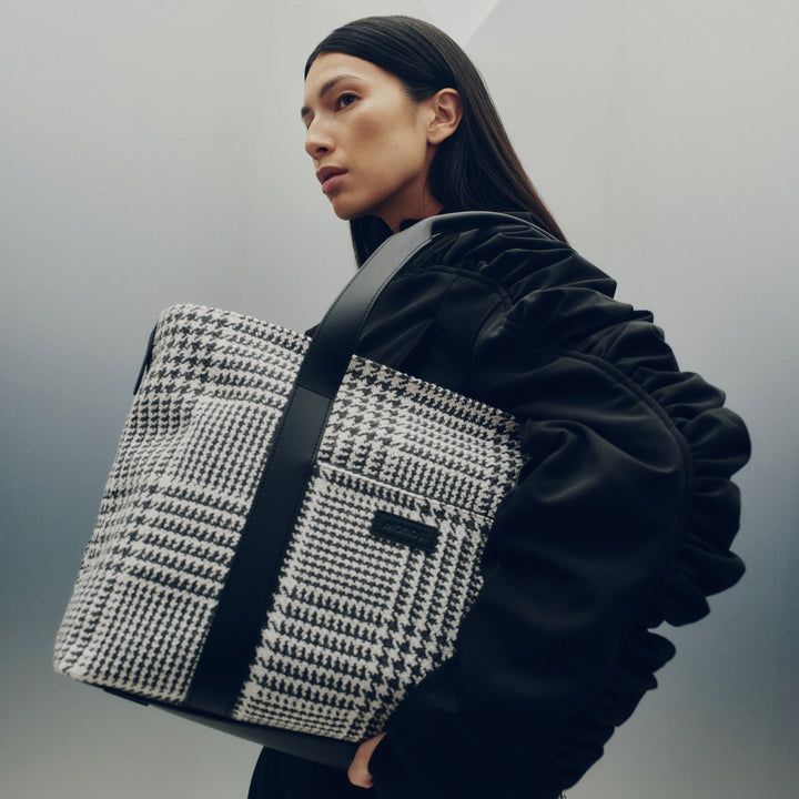 The Metro Tote in Houndstooth Check — a statement piece that combines timeless pattern, modern structure, and everyday versatility.