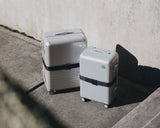 Monos Hybrid luggage with Luggage Strap in Midnight Black, photographed in natural light.