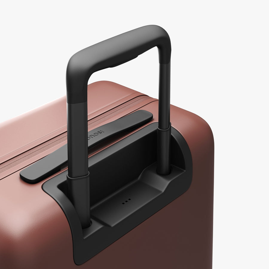 Terracotta | Extended luggage handle view of Carry-On in Terracotta