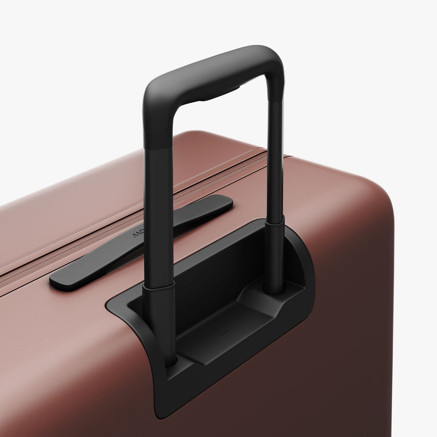 Terracotta | Extended luggage handle view of Check-In Large in Terracotta