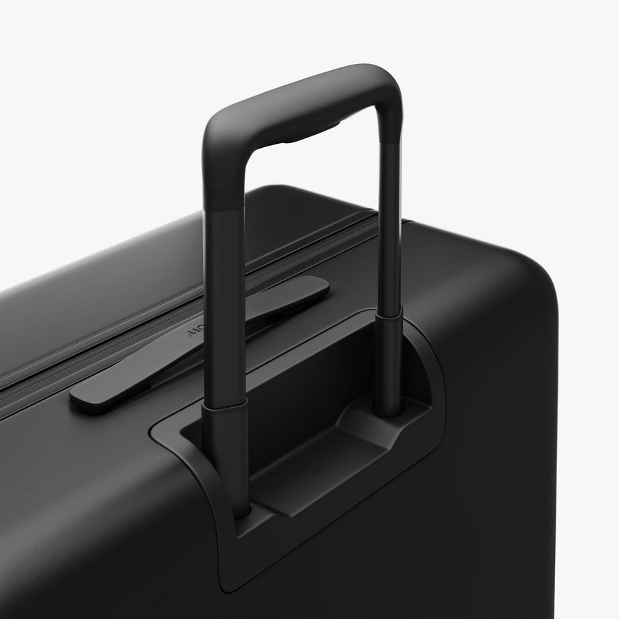 Midnight Black | Extended luggage handle view of Check-In Large in Midnight Black