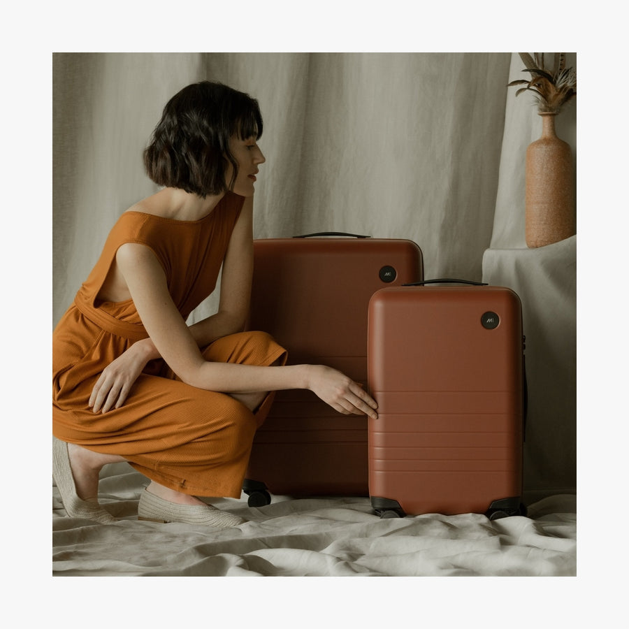 Terracotta | This is a photo of a woman with a Terracotta Check-In and Carry-on